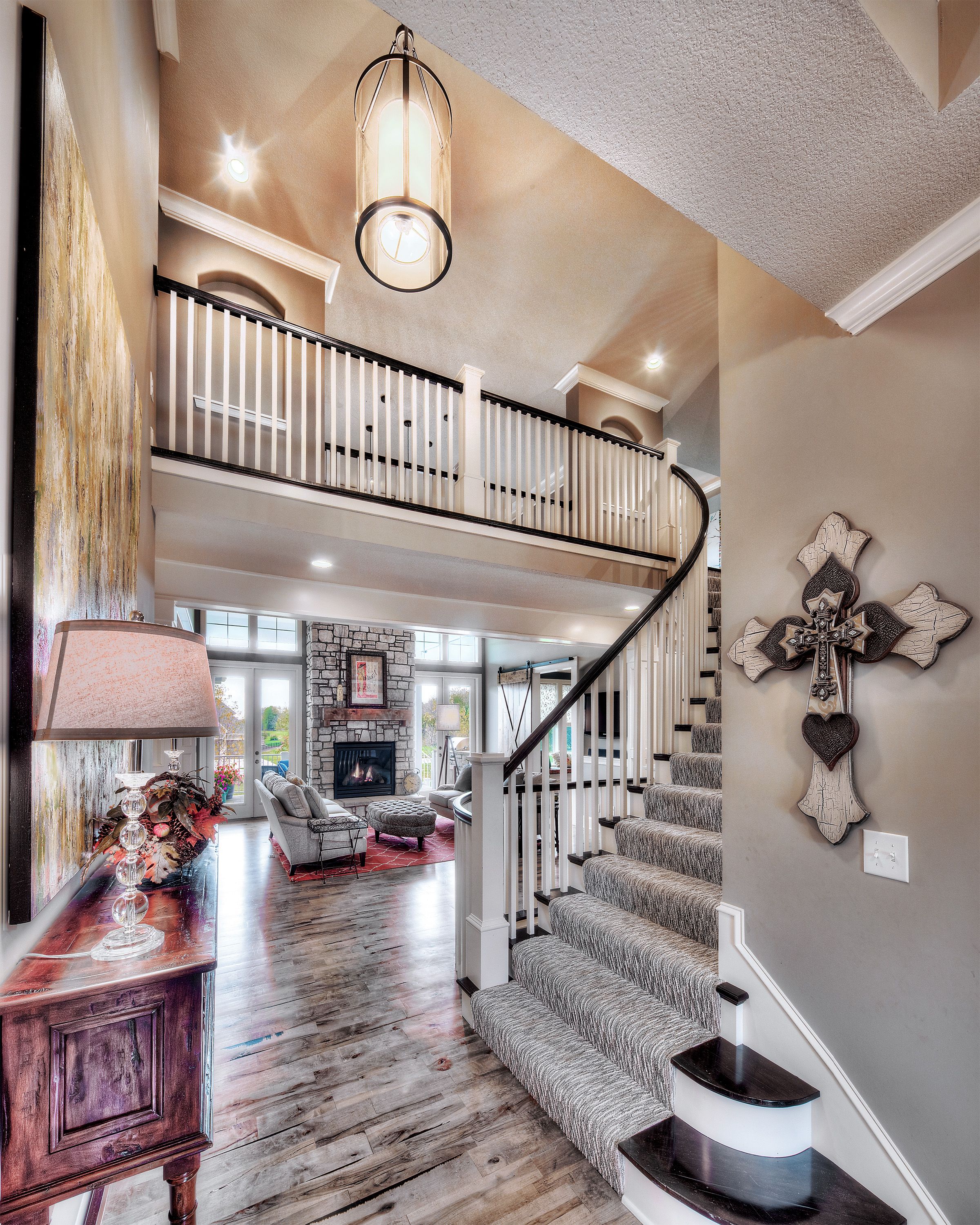 Entry curved staircase, open floor plan, pendant lighting